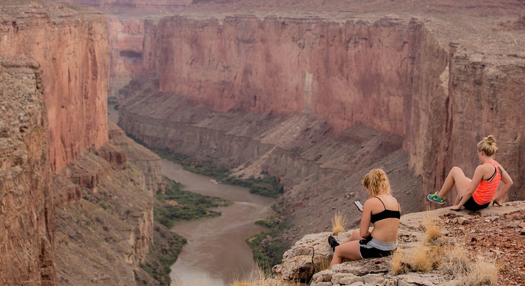 looking at cell phone over Colorado River