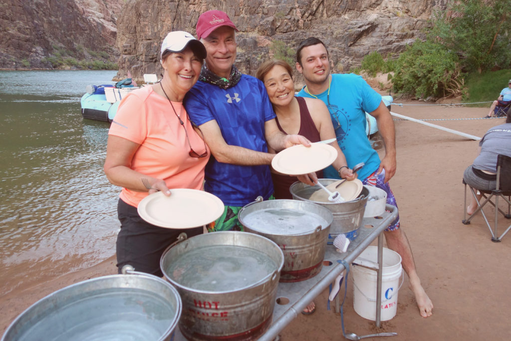 Group smiling doing dishes