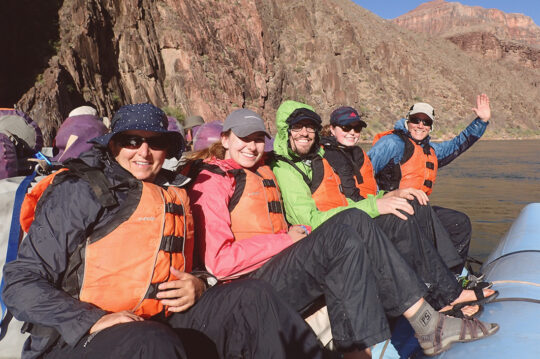Happy guests in rain jackets and rain pants