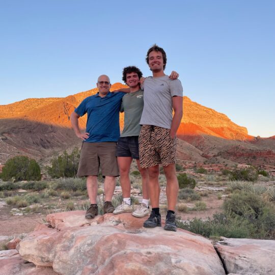 Emlen, center, with his dad Christian, left, and brother Henry, right.