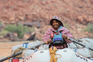 A river guide rows an oar boat.