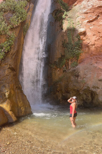 A young woman in front of Deer Creek Falls.