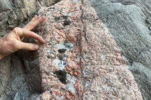 Pointing at crystals in a rock.