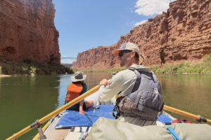 A guide rowing in the Grand Canyon.