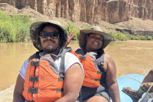 People in life jackets on a boat. 