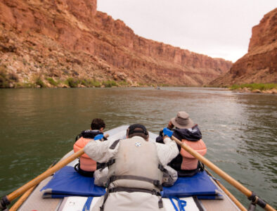 Guide rowing oar boat in flat water.