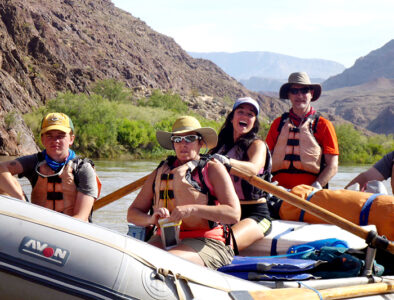 Guide and guests on oar boat