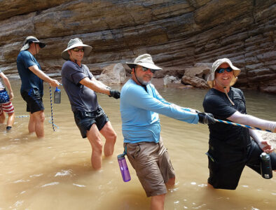 Man smiling and pulling a rope.