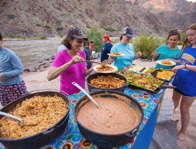 Guests enjoy a hearty dinner on the banks of the Colorado River. Dinner in the Grand Canyon