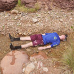 Person laying in a creek to cool off