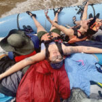 Woman with arms out soaking up the sun on a boat