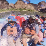 People going through rapids on a motor boat.