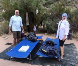 A husband and wife with their cot and tarp/