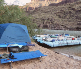 A cot, tent, and boat in Grand Canyon