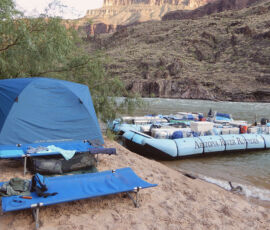 A cot, tent, and boat in Grand Canyon