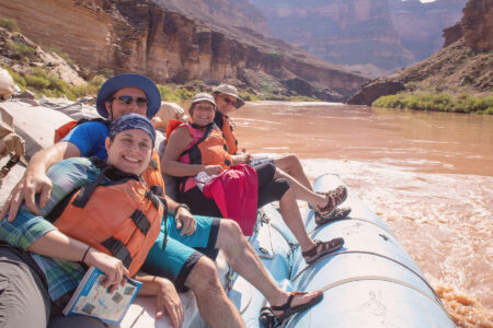 A group of people on a motor boat in the Grand Canyon.