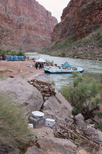 A groover bathroom system in Grand Canyon with a motor boat in the background.