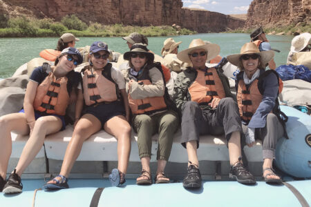 A group of people on a motor boat in the Grand Canyon.