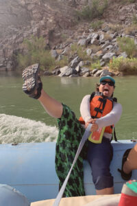 A woman lifting her leg up comedically in the Grand Canyon.