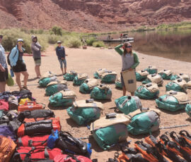 A guide gives orientation surrounded by dry bags.